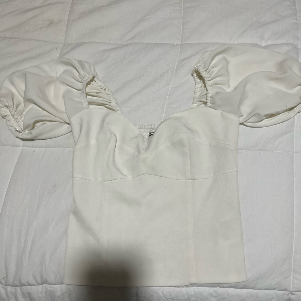 white shirt , mid length sleeves that cuff